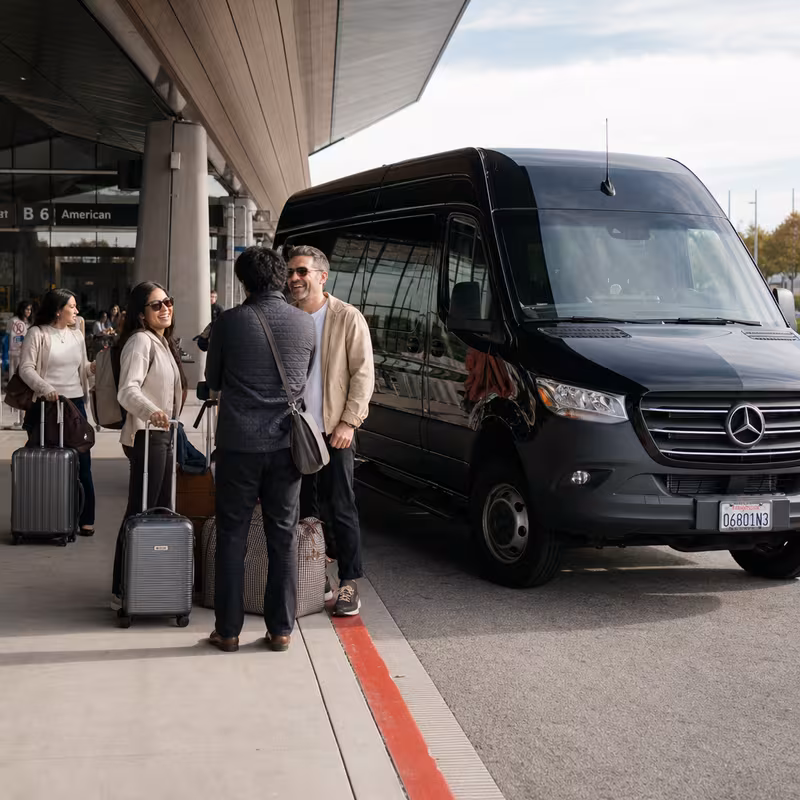 Group boarding a white charter bus for Airport Transportation transportation in Santa Rosa