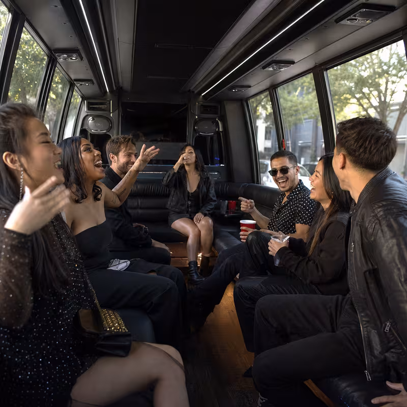 Group boarding a white charter bus for Concert Transportation transportation in Santa Rosa