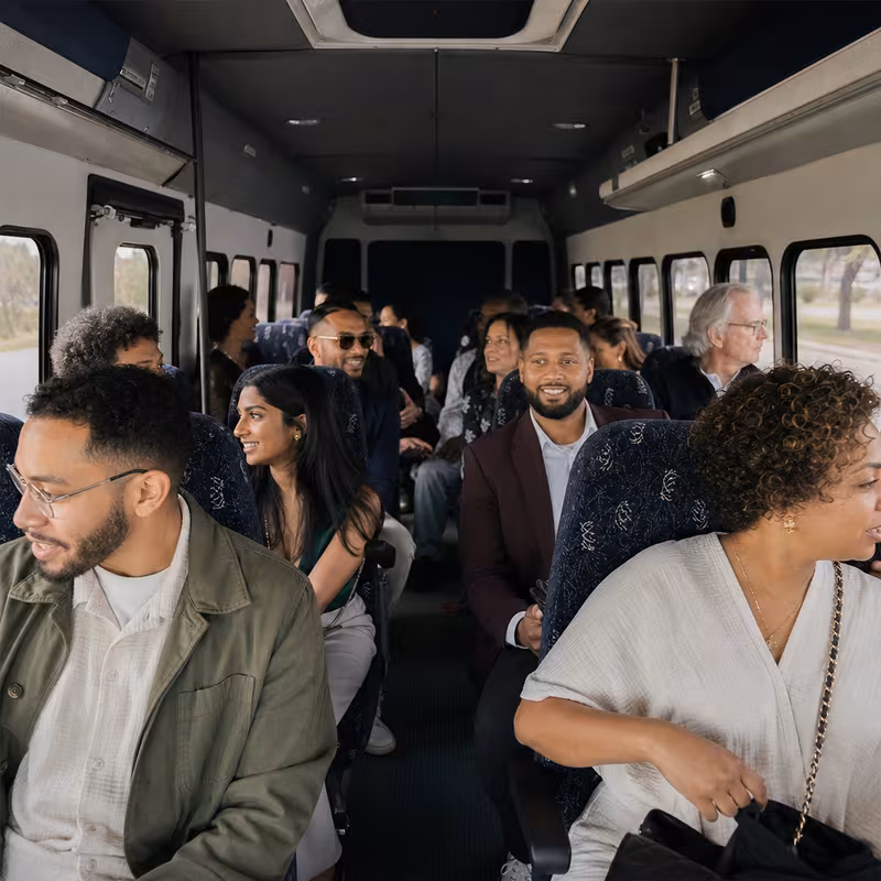Group boarding a white charter bus for Private Event Transportation transportation in Santa Rosa