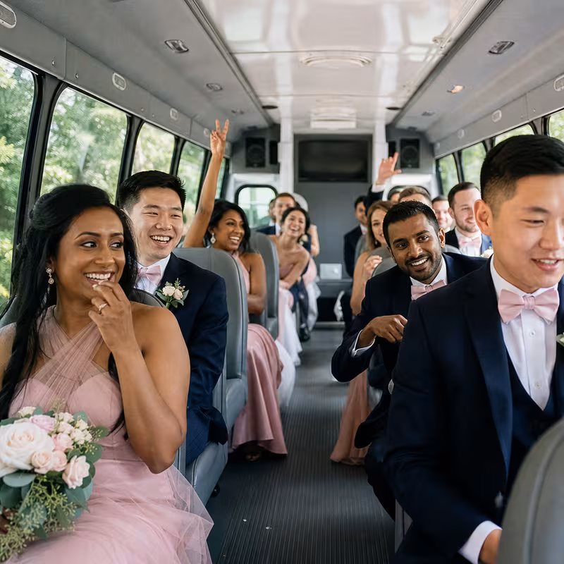 Group boarding a white charter bus for Wedding Transportation transportation in Santa Rosa